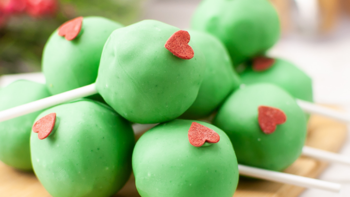 Grinch Cake Pops on cutting board