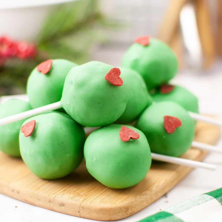 Grinch Cake Pops on cutting board