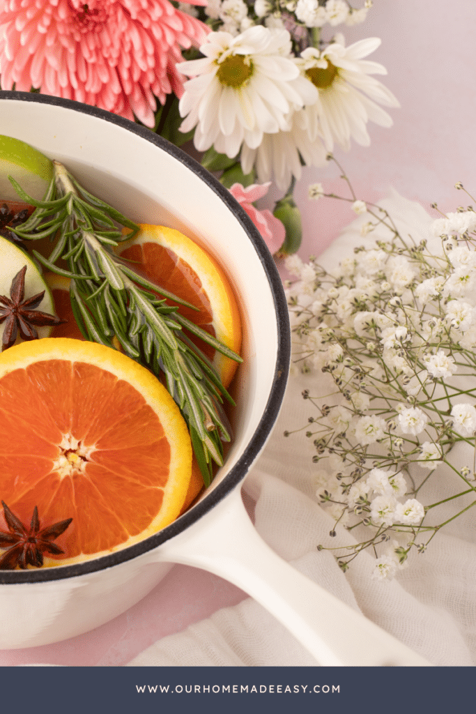 simmer pot with oranges in a white cast iron pot