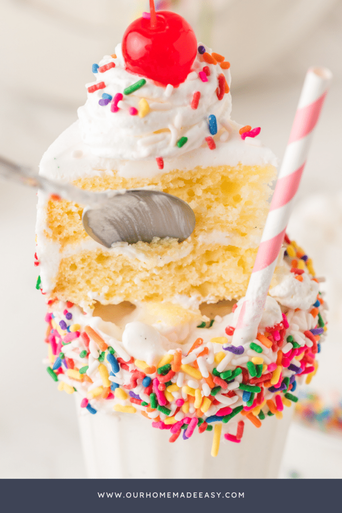 spoon taking bite out of vanilla cake