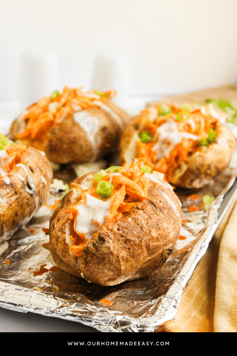 loaded baked potato on baking sheet