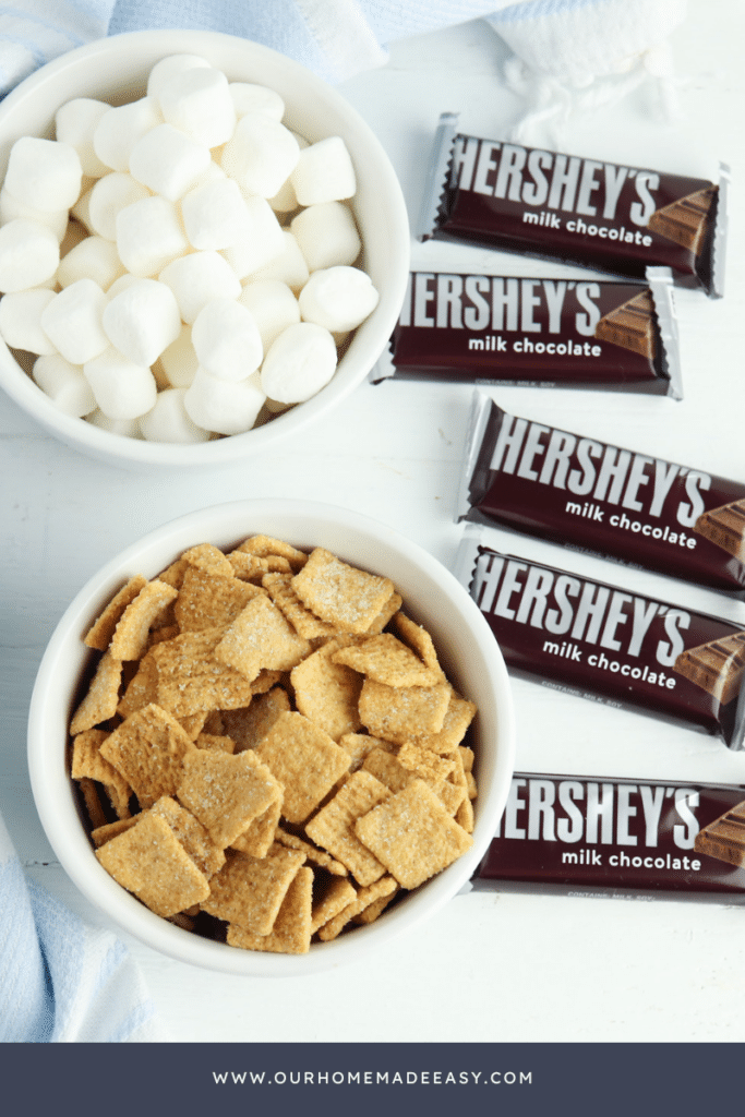 s'mores snack mix ingredients on blue tablecloth