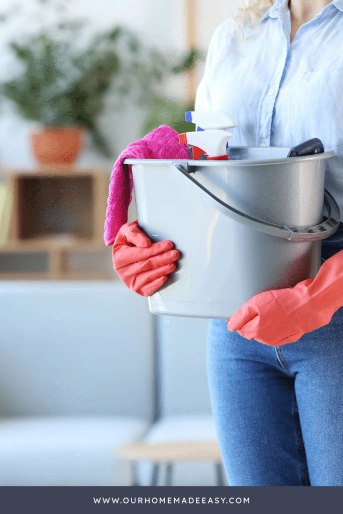 Woman holding cleaning supplies in living room