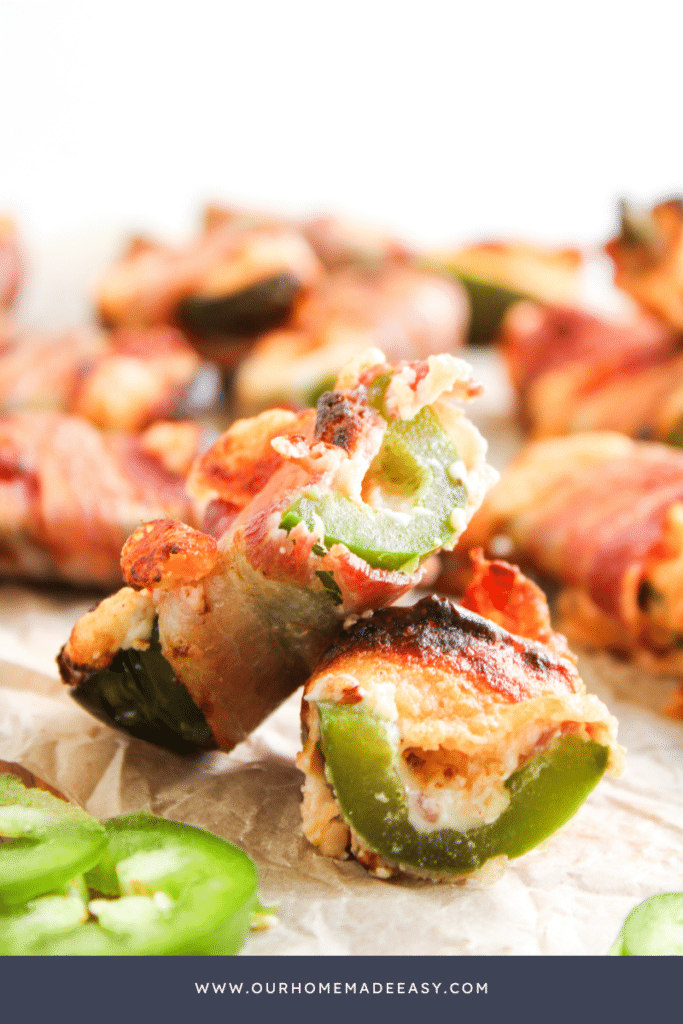 bite shot of bacon wrapped jalapeno poppers