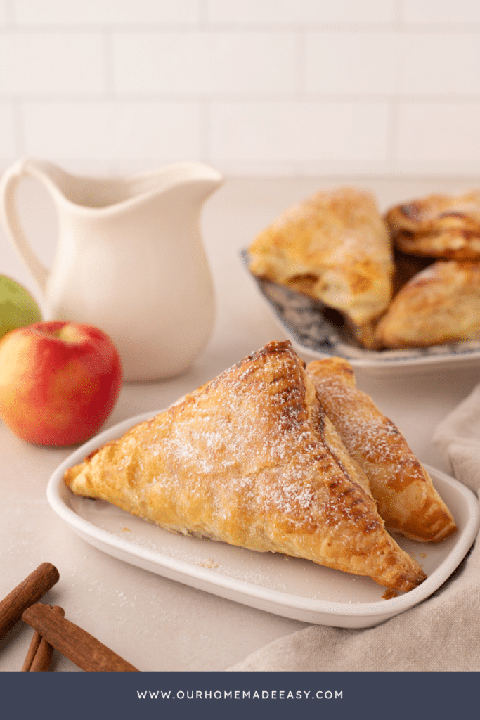 two apple hand pies on white plate