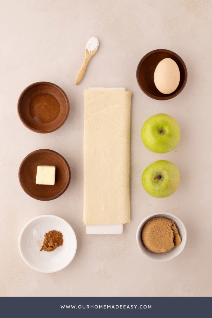 Apple turnovers with puff pastry ingredients on countertop