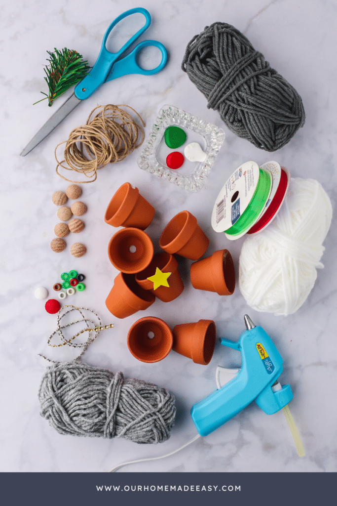 Gnome ornament supplies laying on marble countertop