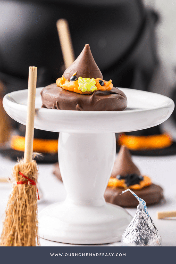 Decorated witch's hat cookies on tier