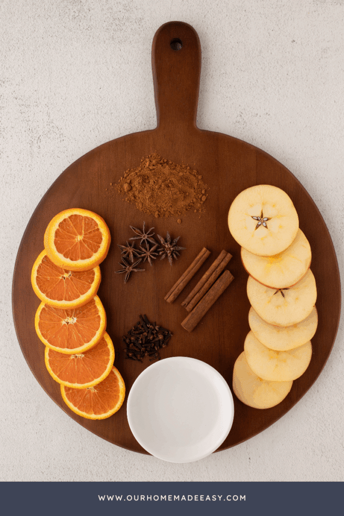 fresh fall simmer pot ingredients sliced on wooden cutting board