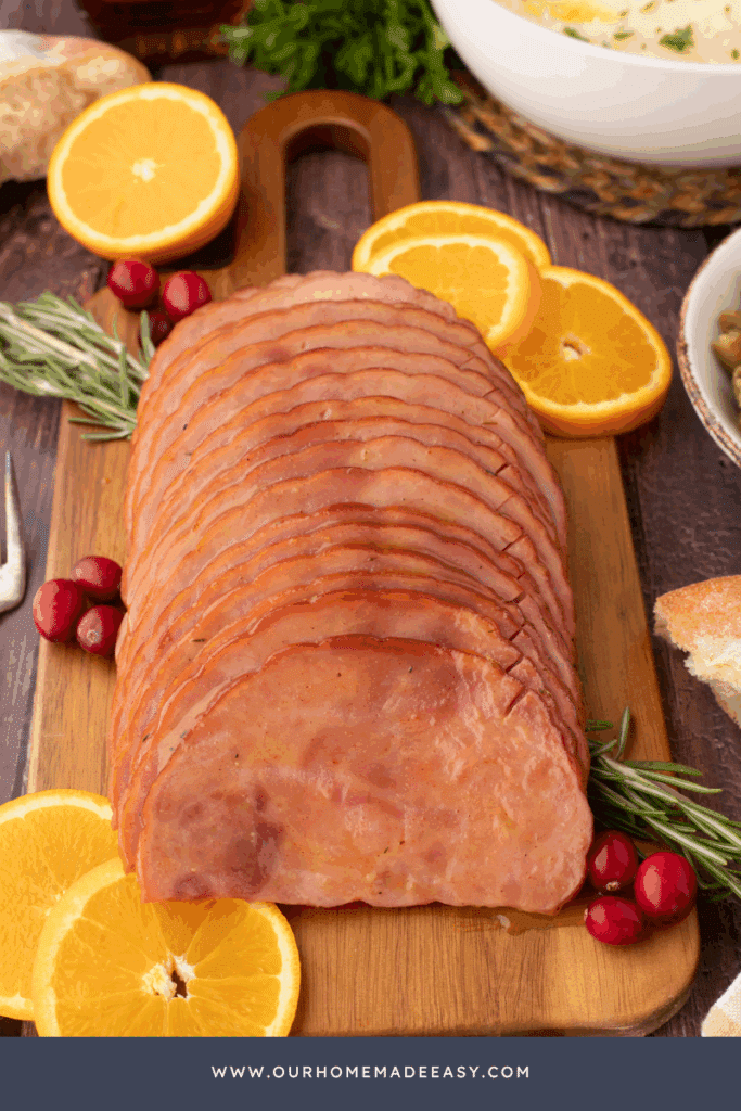 finished maple glazed ham on wood board sliced