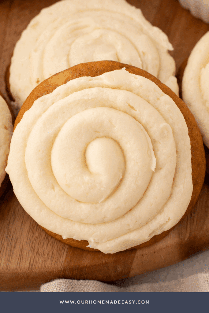 close up of soft pumpkin cookies frosted