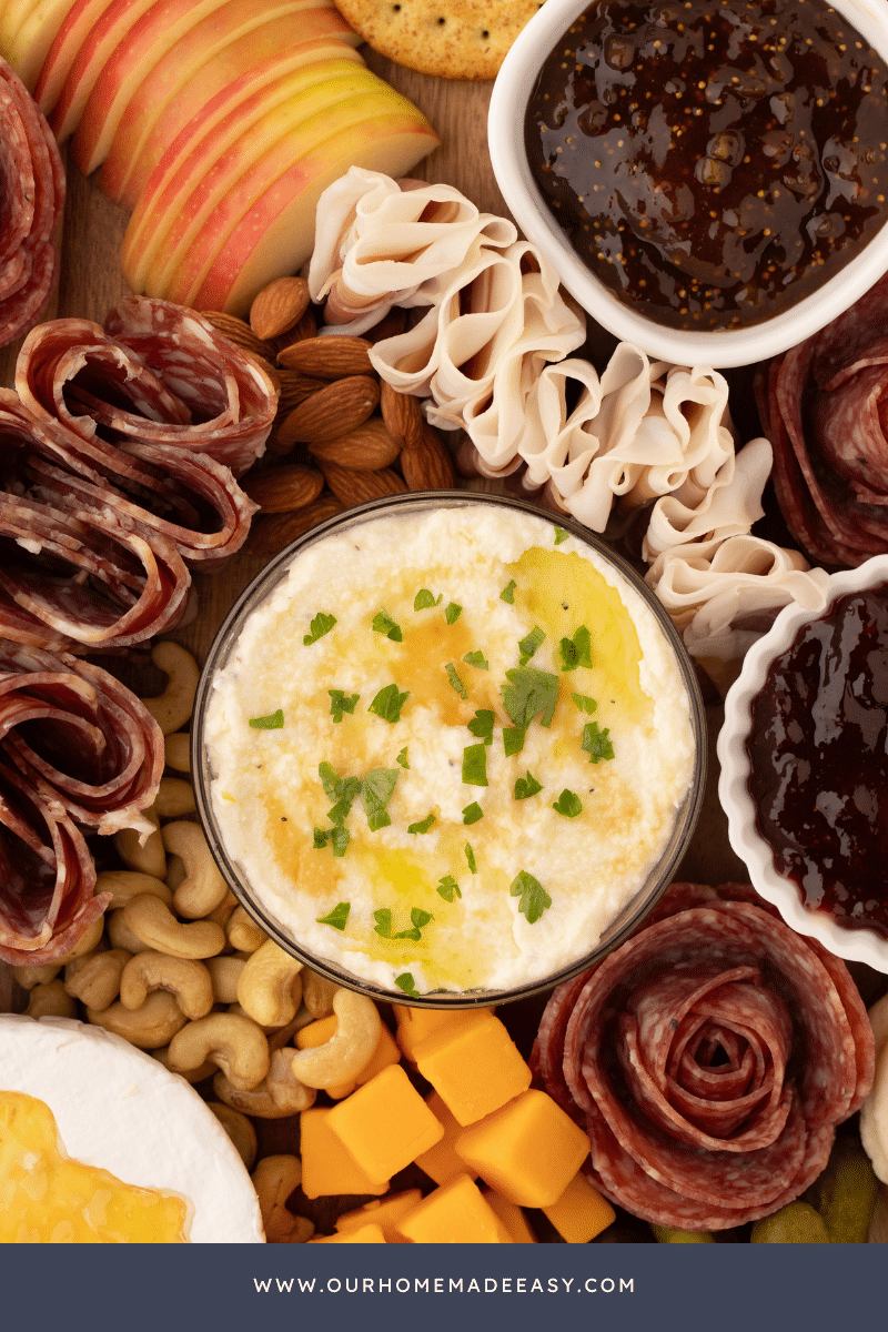 finished whipped ricotta dip surrounded by meat and cheese