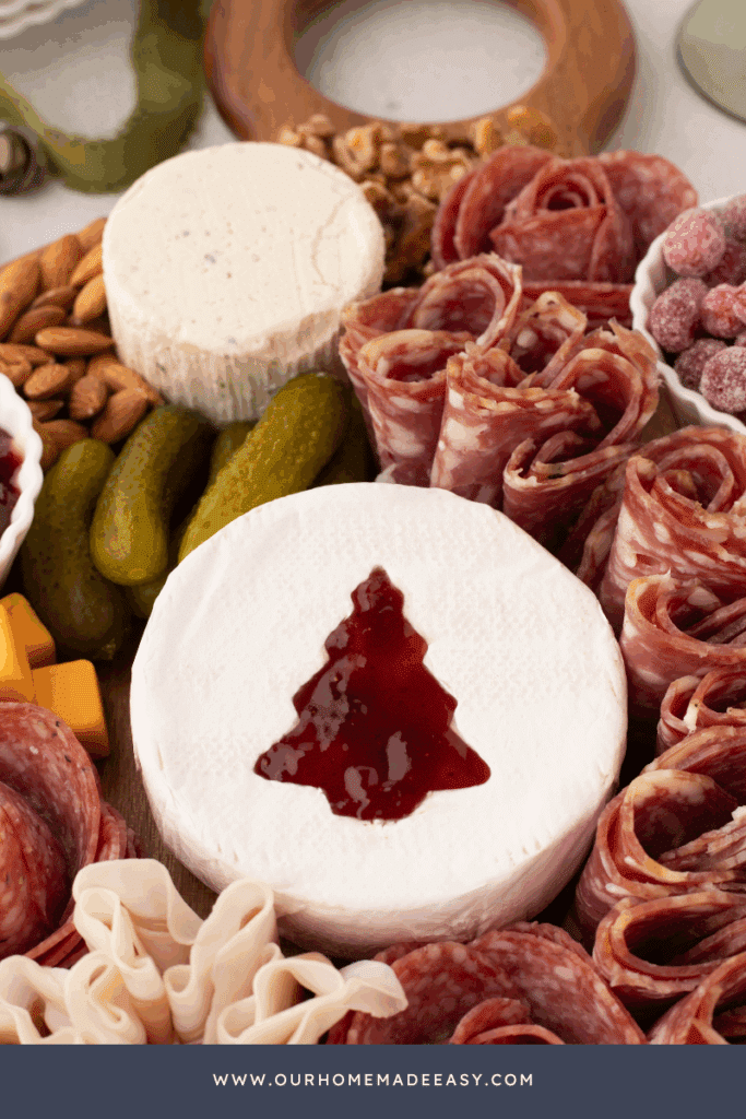 boursin cheese, salami roses, and holiday brie cheese cutout