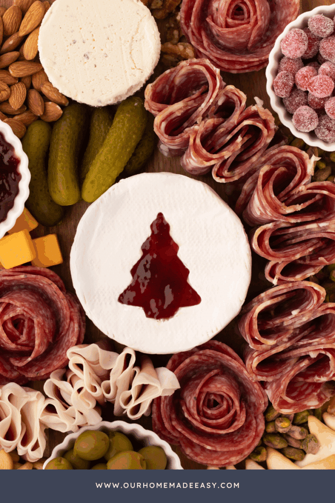 close up of christmas tree Brie cheese cutout with raspberry jelly