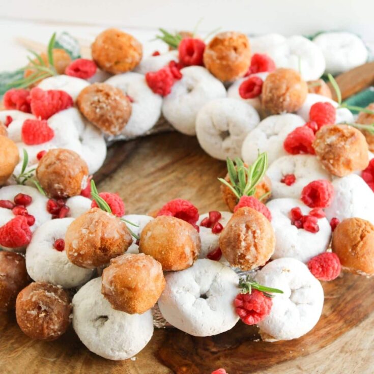 finished no bake mini powdered donuts assembled in a Christmas wreath shape with donut holes