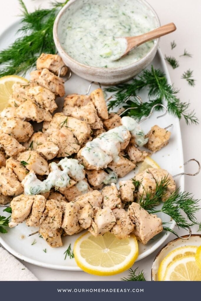 grilled chicken and tzatziki sauce with lemons