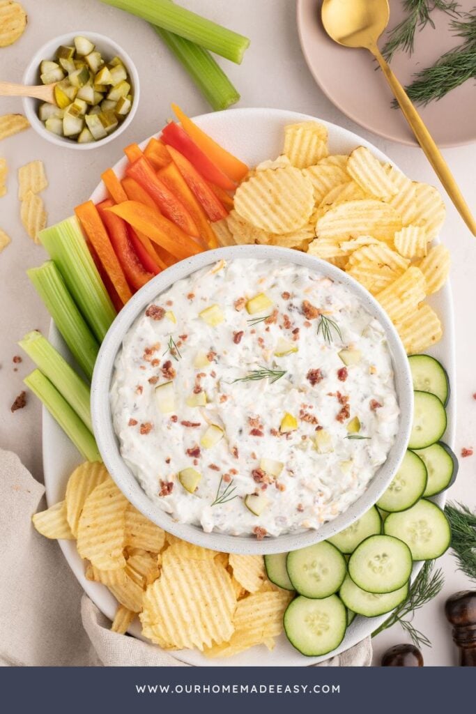 looking down at creamy dill pickle dip recipe with a snack board