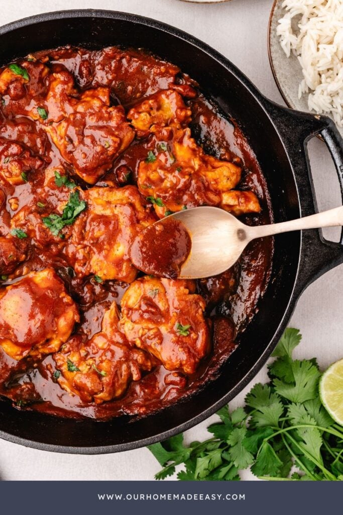 spooning homemade smokey glaze over chicken thighs