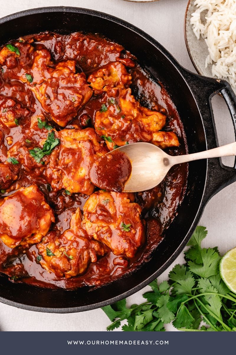 spooning homemade smokey glaze over chicken thighs