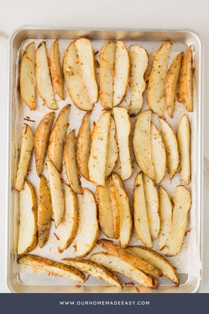 oven baked parmesan potato wedges on baking sheet
